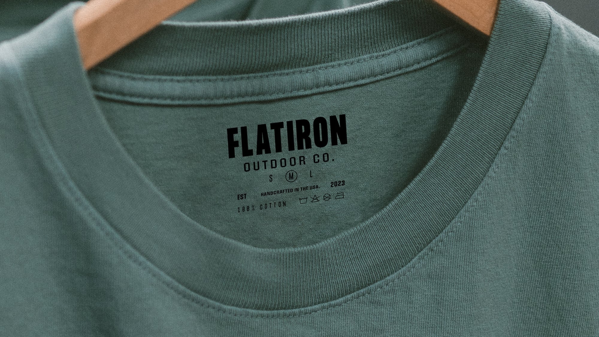 Interior neck label detail of a premium forest green t-shirt from Flatiron Outdoor Co.